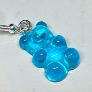 Pair of Blue plastic gummy bear earrings in a little blue box.